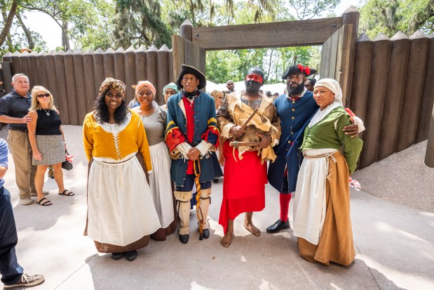 Reenactors gather for a photo during a ribbon-cutting ceremony for a new replica 1738 fort at Fort Mose Historic State Park in St. Augustine on May 9. (Patrick Connolly/Orlando Sentinel)